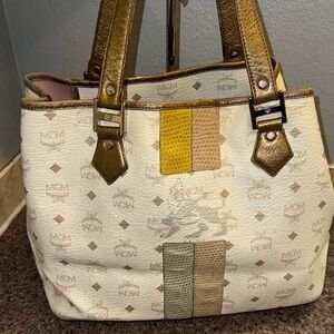 MCM lioness Tote with Metallic Gold Handles and snake embossed strip EUC.